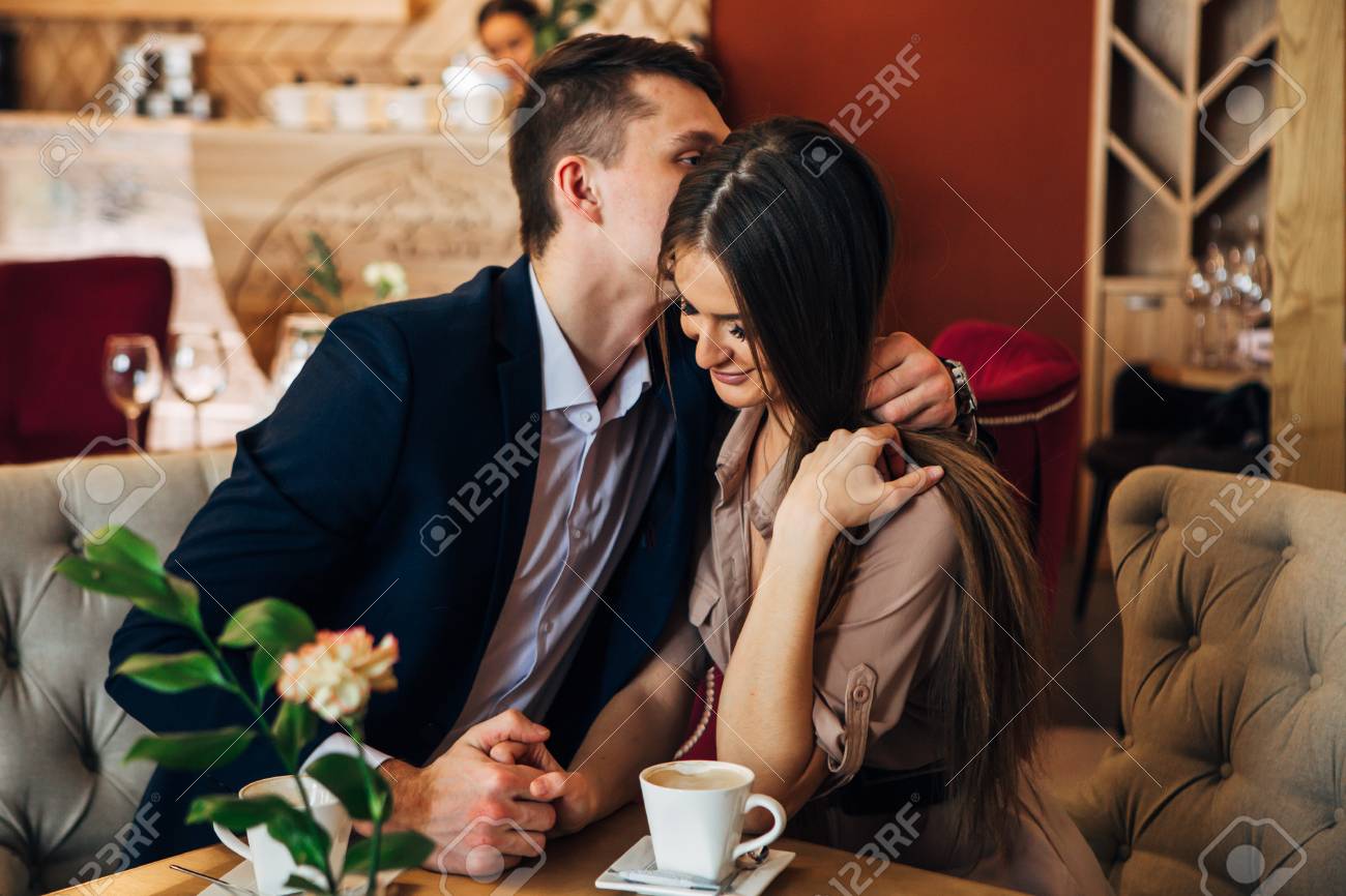 Happy young couple taking selfie with smart phone at cafe - 97567345 Happy young couple taking selfie with smart phone at cafe - 97567345
