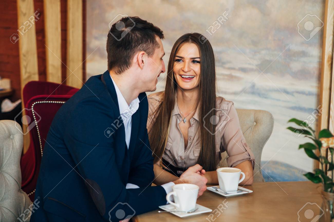 Happy young couple taking selfie with smart phone at cafe - 97567354 Happy young couple taking selfie with smart phone at cafe - 97567354