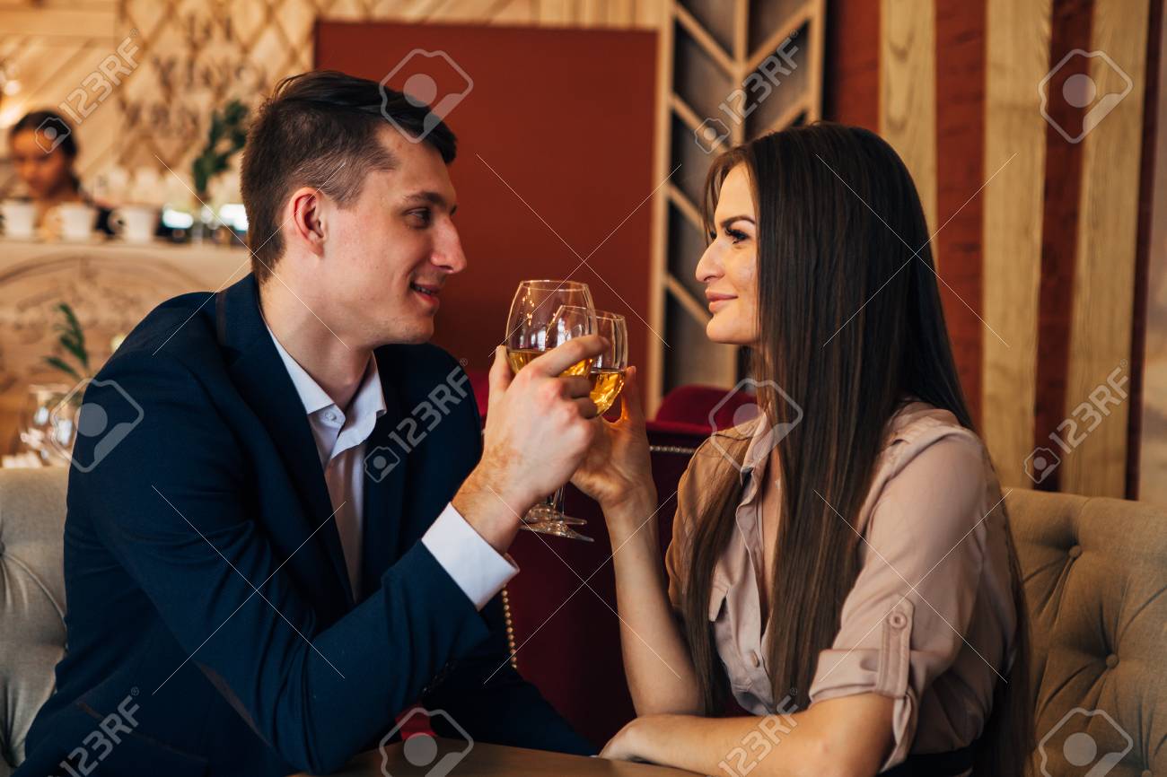 Dating concept, couple drinking wine in a restaurant - 97567466 Dating concept, couple drinking wine in a restaurant - 97567466