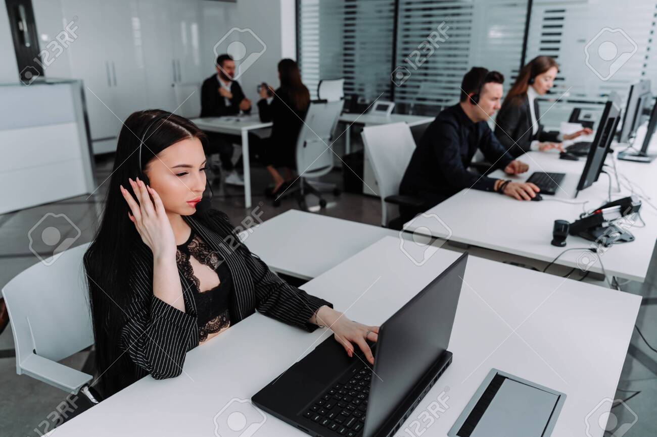 A team of business people working in a call center on the line. - 143173696 A team of business people working in a call center on the line. - 143173696