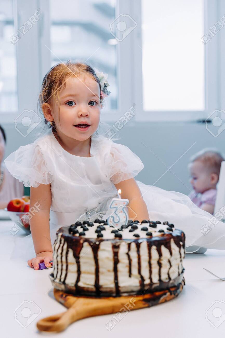 Portrait of cute little girl celebrating third birthday. - 145784001 Portrait of cute little girl celebrating third birthday. - 145784001
