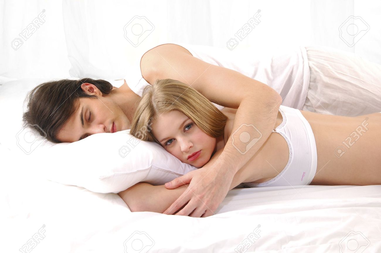 Lovely Couple In Bed Lying In Bedroom
