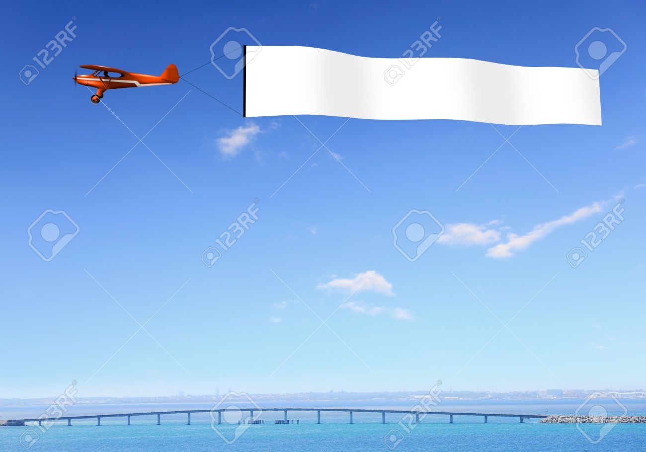 plane in the sky above the city with blank flag stock photo picture