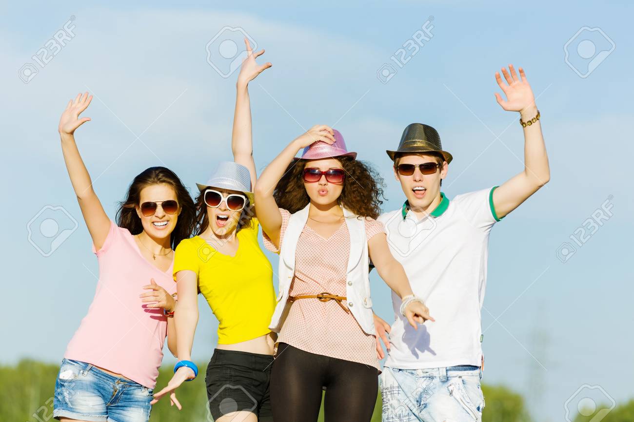 Young Happy People Having Fun Outside In Summer Stock Photo, Picture And  Royalty Free Image. Image 25576450.