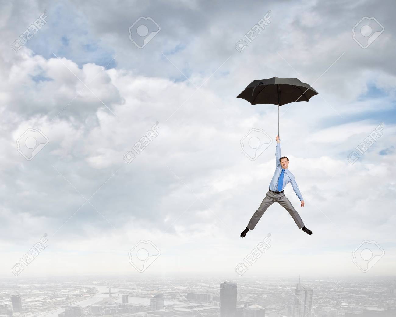 Young Businessman Flying High In Sky On Umbrella Stock Photo Picture And Royalty Free Image Image