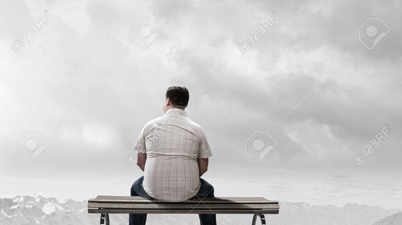Fat Man Sitting On Bench With His Back And Looking Away Stock Photo Picture And Royalty Free Image Image
