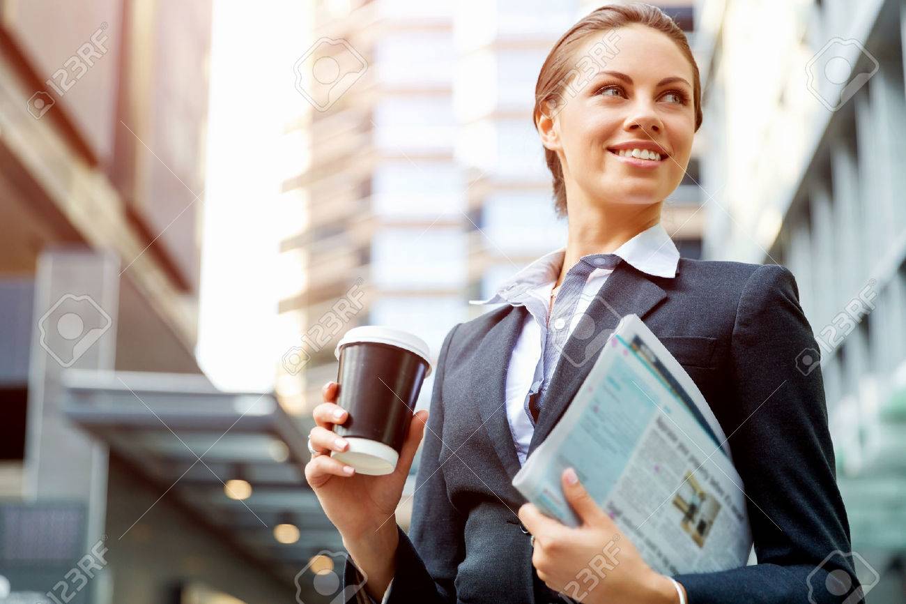 Portrait of young business woman walking in city - 54535324 Portrait of young business woman walking in city - 54535324