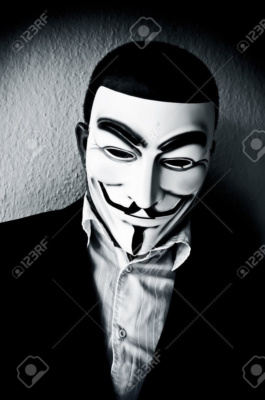 PARIS - France - 22 April 2015 - man wearing suit businessman and Vendetta mask. This mask is a well-known symbol for the on line hacktivist group Anonymous - 39069398 PARIS - France - 22 April 2015 - man wearing suit businessman and Vendetta mask. This mask is a well-known symbol for the on line hacktivist group Anonymous - 39069398