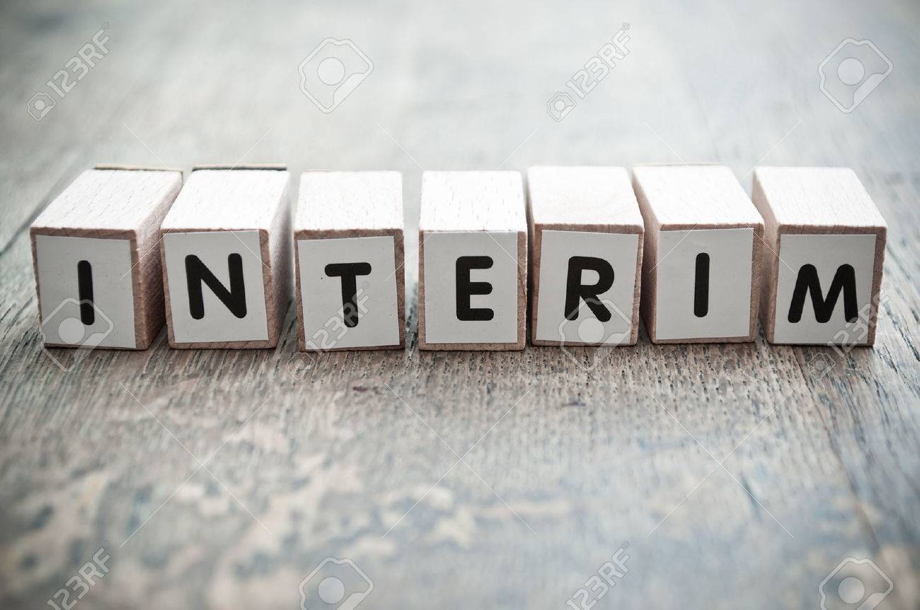 concept word forming with cube on wooden desk background - interim - 50885429 concept word forming with cube on wooden desk background - interim - 50885429