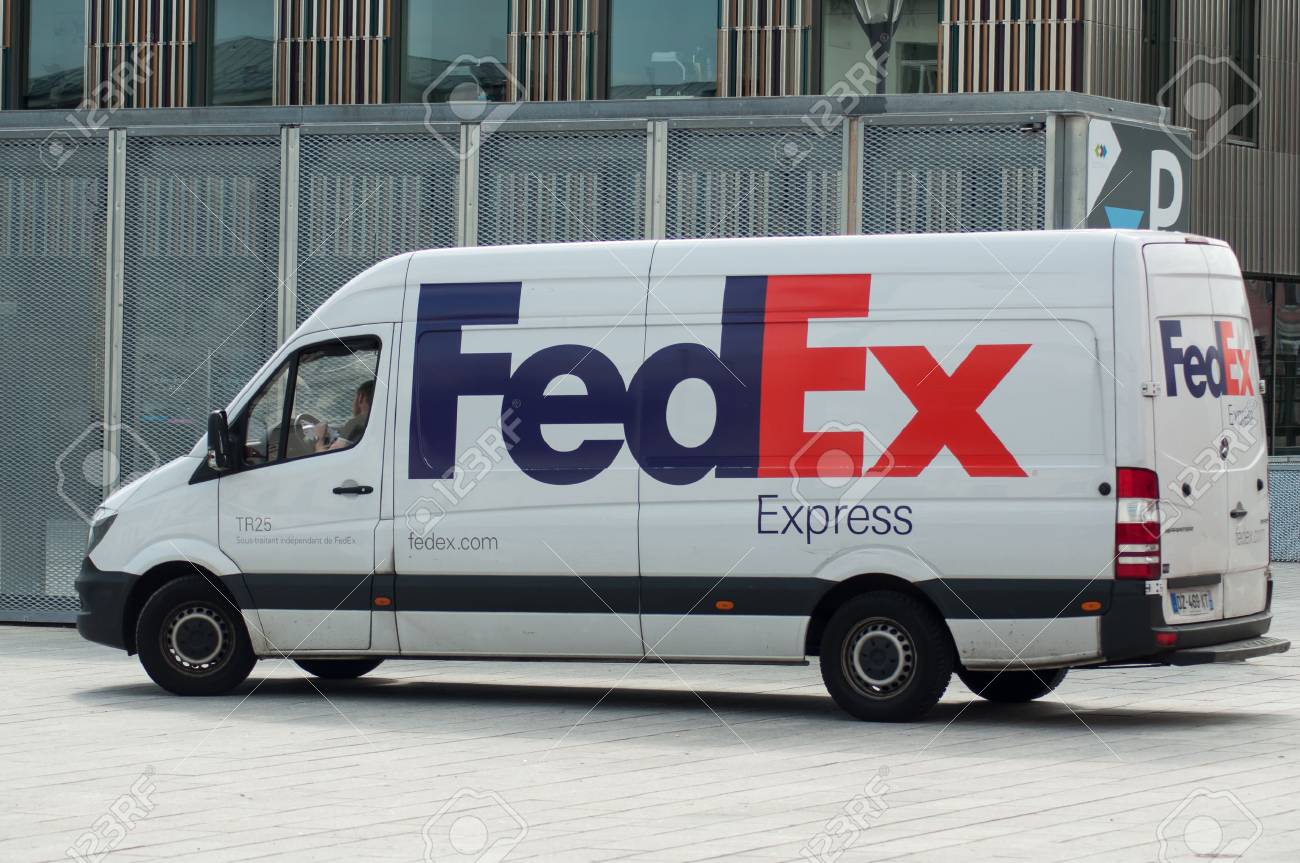 Mulhouse - France - 31 May 2018 - Fedex delivery truck parked in the street near train station - 104639675 Mulhouse - France - 31 May 2018 - Fedex delivery truck parked in the street near train station - 104639675