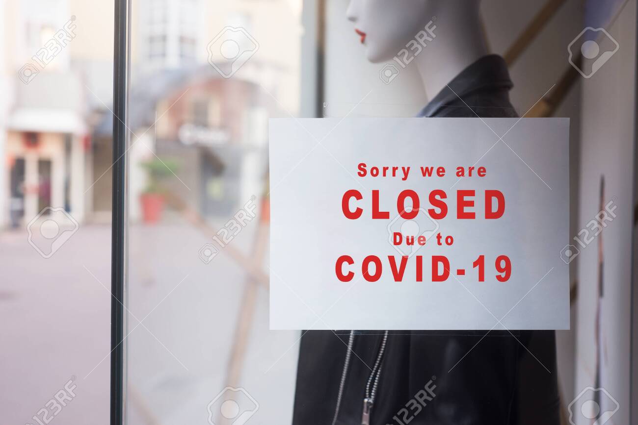 Closeup of information sign on the window of the fashion store front : Sorry we are Closed due to covid-19 - 144596291 Closeup of information sign on the window of the fashion store front : Sorry we are Closed due to covid-19 - 144596291