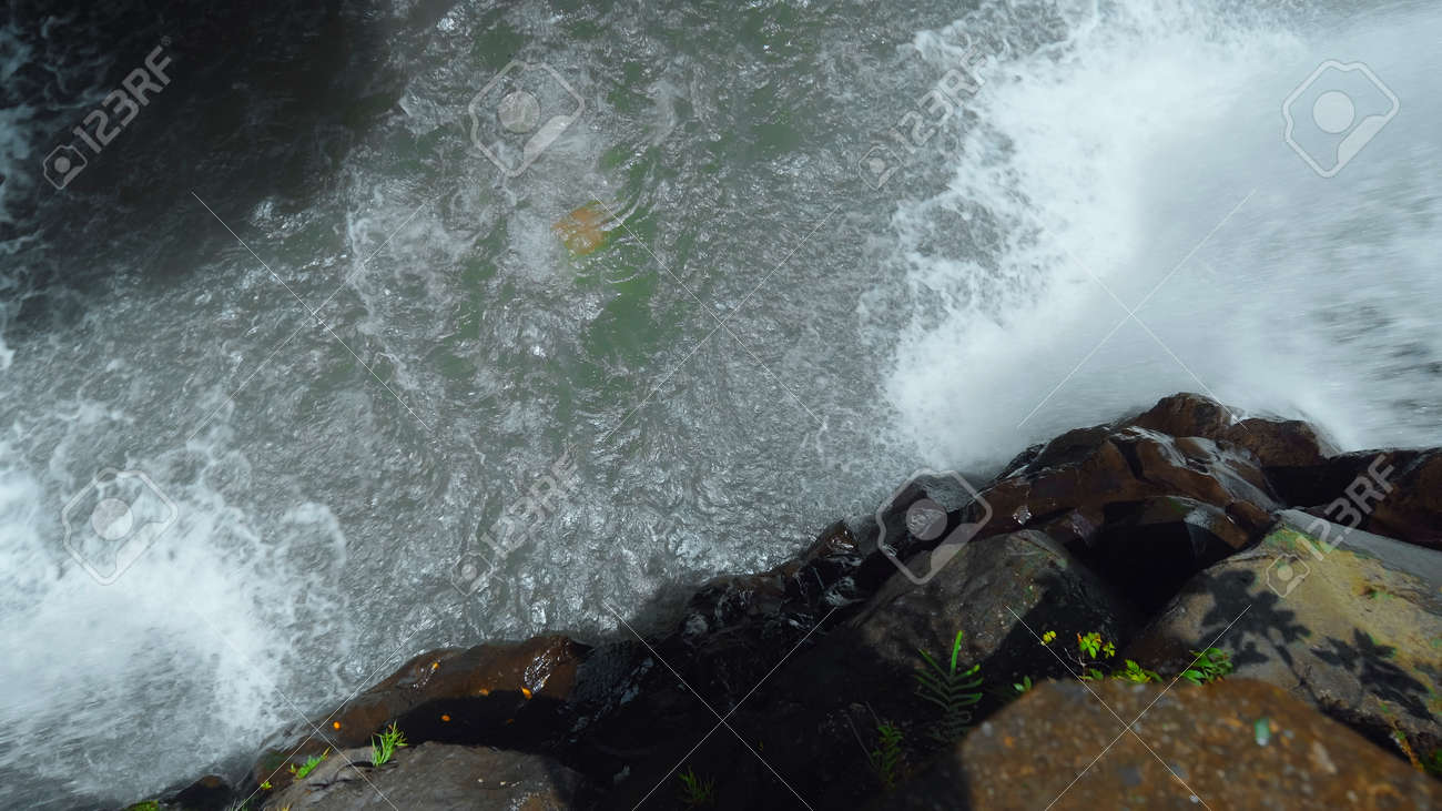 Picture of waterfall with rocks among tropical jungle with green plants trees and river. - 170497063 Picture of waterfall with rocks among tropical jungle with green plants trees and river. - 170497063