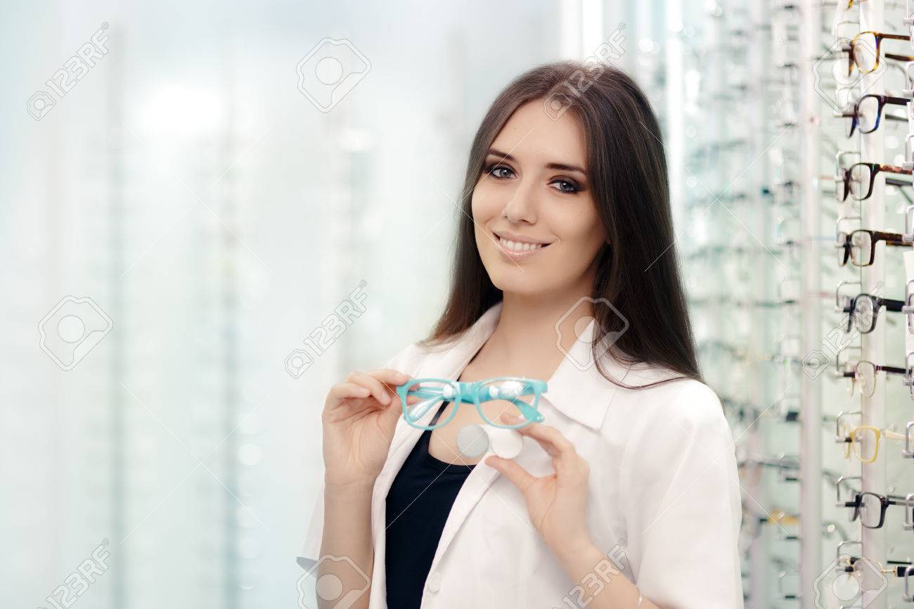 Happy Optician Choosing between Glasses and Contact Lenses - 62774706 Happy Optician Choosing between Glasses and Contact Lenses - 62774706