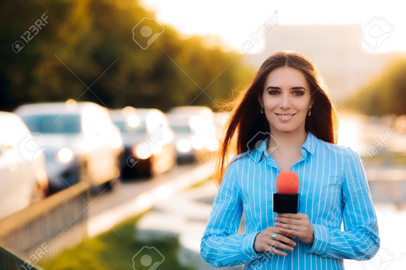 Female News Reporter on Field in Traffic - 78417798 Female News Reporter on Field in Traffic - 78417798