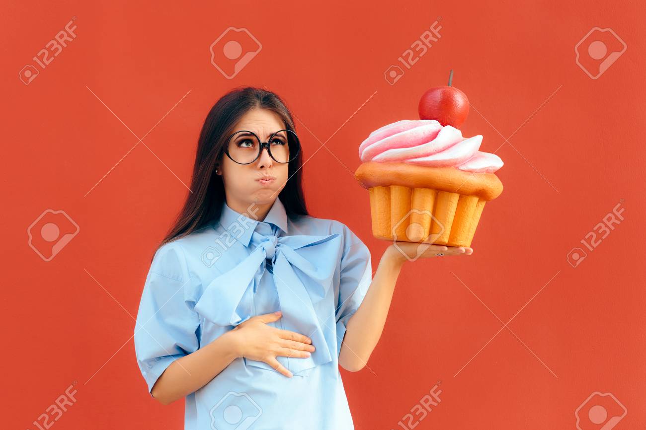 Woman Suffering Stomach Ache After Eating Too Much Cupcake - 93476667 Woman Suffering Stomach Ache After Eating Too Much Cupcake - 93476667