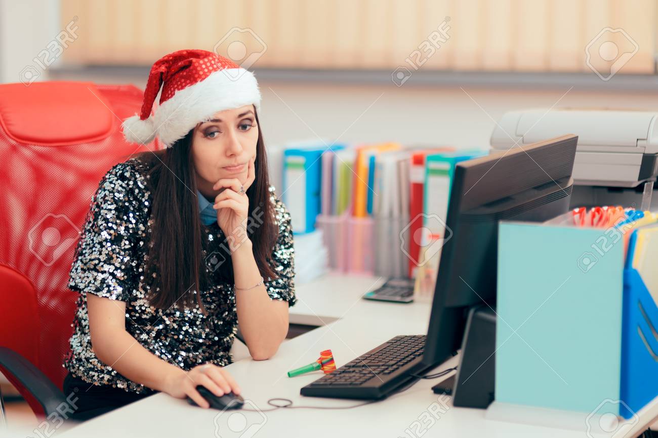 Sad Woman Spending Christmas Holiday at the Office - 110775928 Sad Woman Spending Christmas Holiday at the Office - 110775928