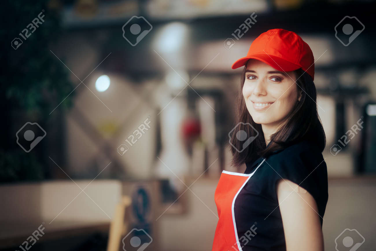 Happy Smiling Fast-Food Worker Standing in a Restaurant - 171551768 Happy Smiling Fast-Food Worker Standing in a Restaurant - 171551768