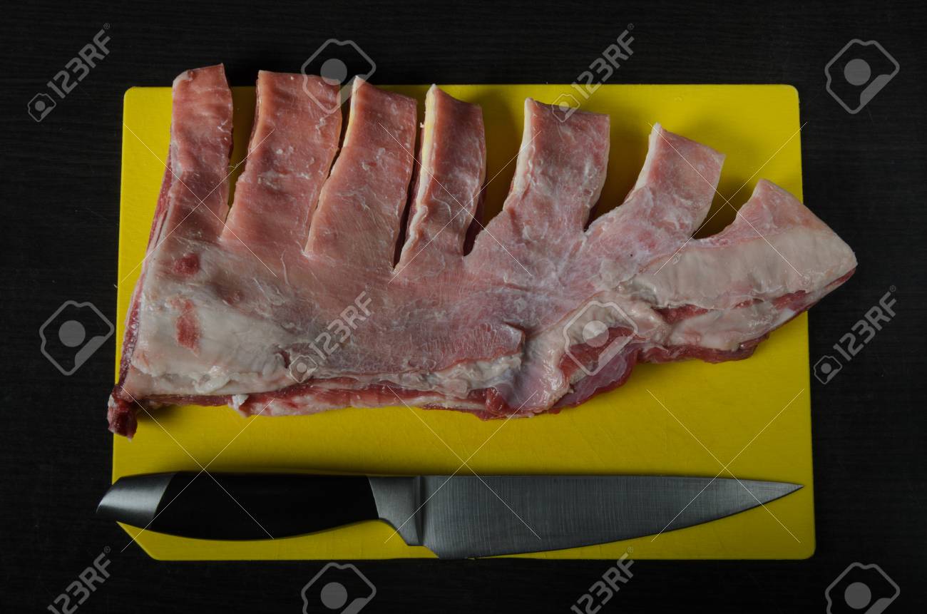 Meat Lamb Ribs Cut With A Knife On A Yellow Cutting Board On A Dark Background Stock Photo Picture And Royalty Free Image Image 96846145