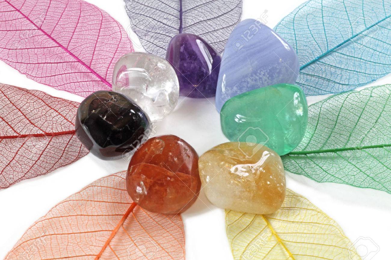 Close up of chakra stones on skeleton leaves - 29022490 Close up of chakra stones on skeleton leaves - 29022490