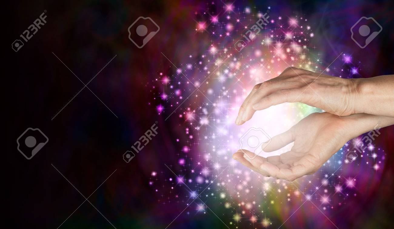 Magi sensing supernatural healing energy - Female cupped hands with a beautiful sparkling ball of white sparkle filled light around and between on a deep colored background - 56095803 Magi sensing supernatural healing energy - Female cupped hands with a beautiful sparkling ball of white sparkle filled light around and between on a deep colored background - 56095803