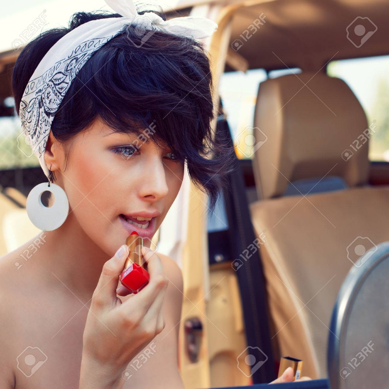 A Beautiful Young Girl With Short Hair Cut And Blue Eyes Is Standing