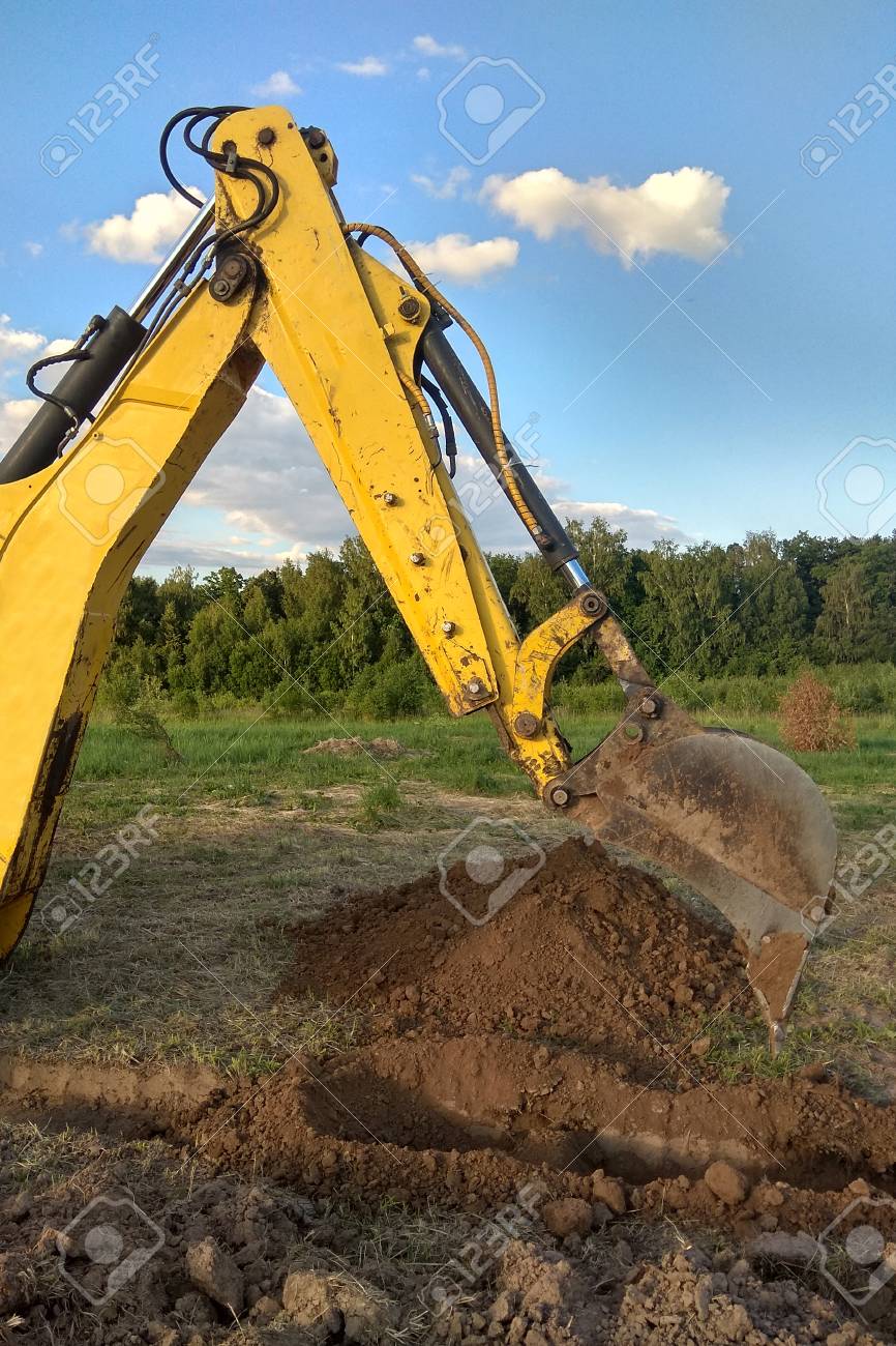 view from above at working excavator tractor digging a trench stock