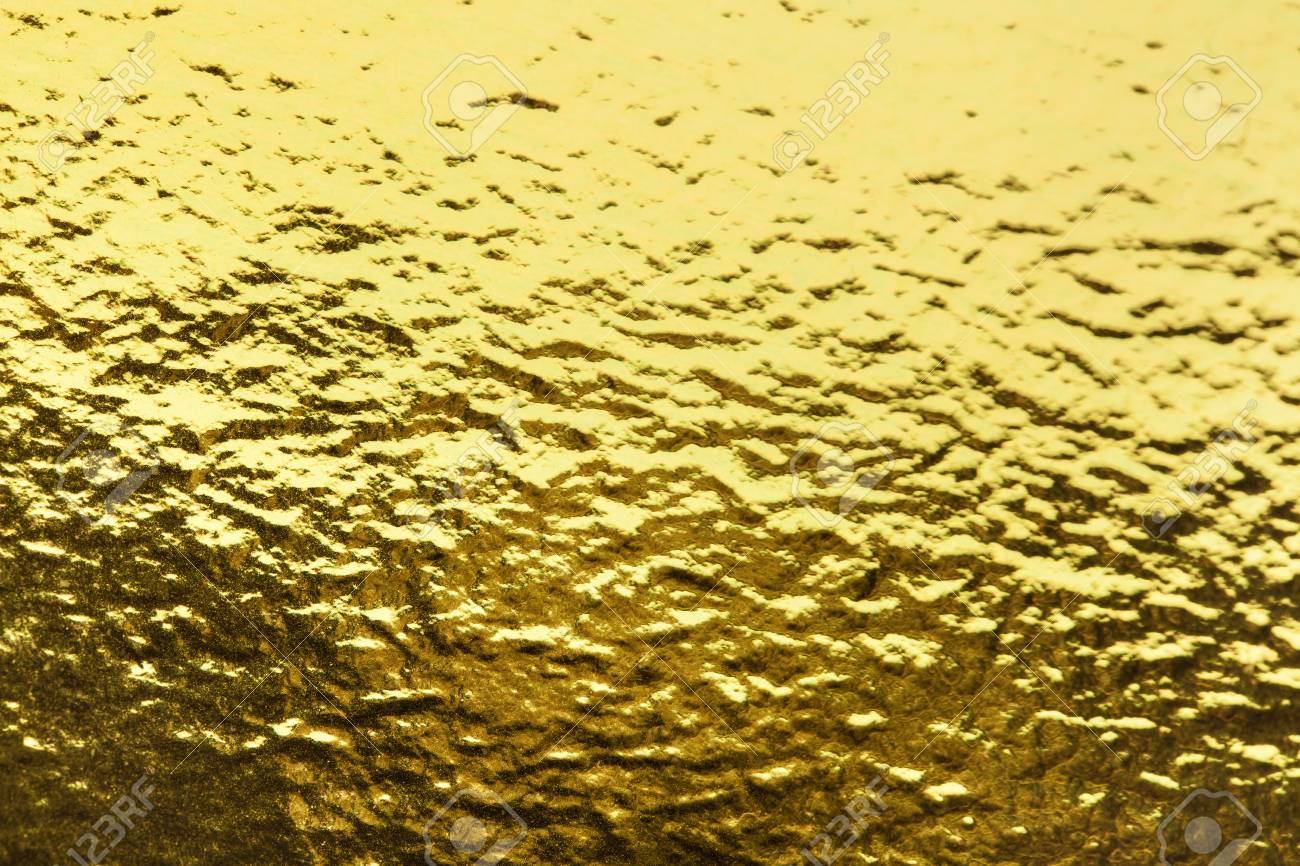 gold shiny texture of a foil background a sheet of sparkling golden sheet