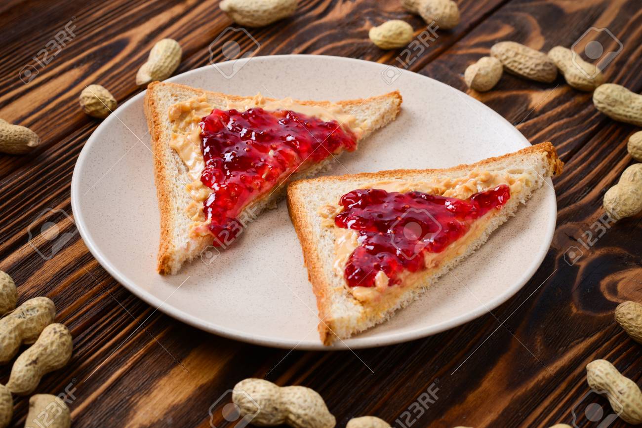 Peanut Butter And Jelly Sandwich On Wooden Background Space