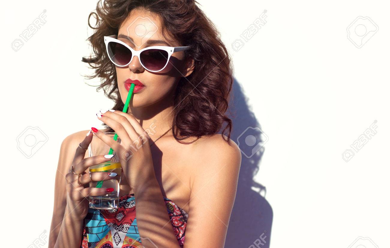 Summer style portrait of young attractive woman wearing sunglasses drinking water. Tropical summer holiday fashion beauty concept - 61832845 Summer style portrait of young attractive woman wearing sunglasses drinking water. Tropical summer holiday fashion beauty concept - 61832845