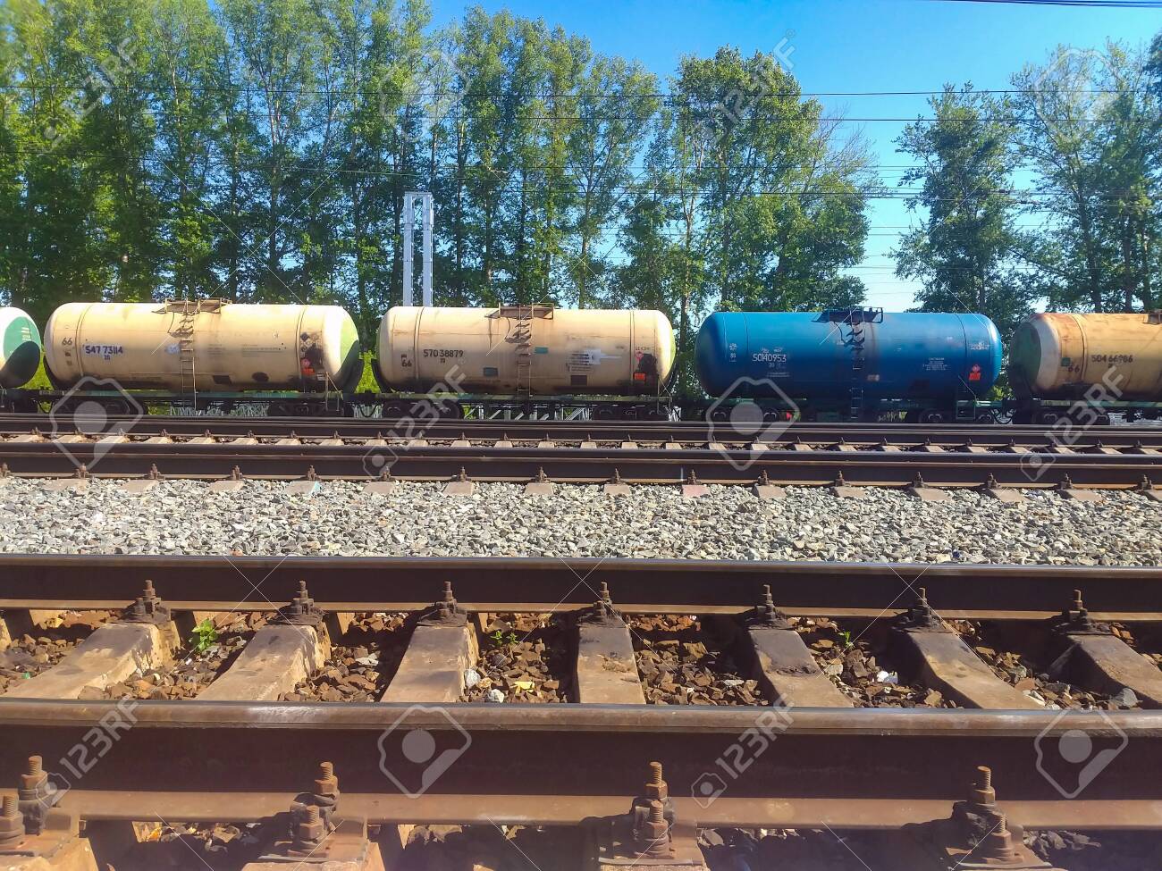 Freight Train Tracks Near Me Railroad Tracks At The Station, Rails Are Horizontally Located. In The  Background A Freight Train With