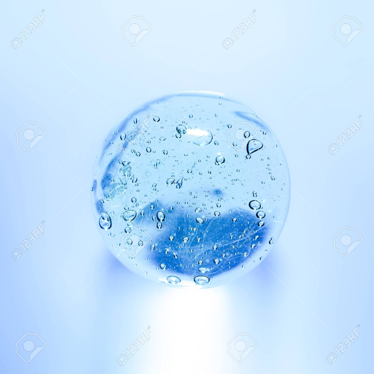 Transparent gel with bubbles close-up. Smear of face gel cream. The texture of gel cream. A sample of a cosmetic product. - 126094850 Transparent gel with bubbles close-up. Smear of face gel cream. The texture of gel cream. A sample of a cosmetic product. - 126094850