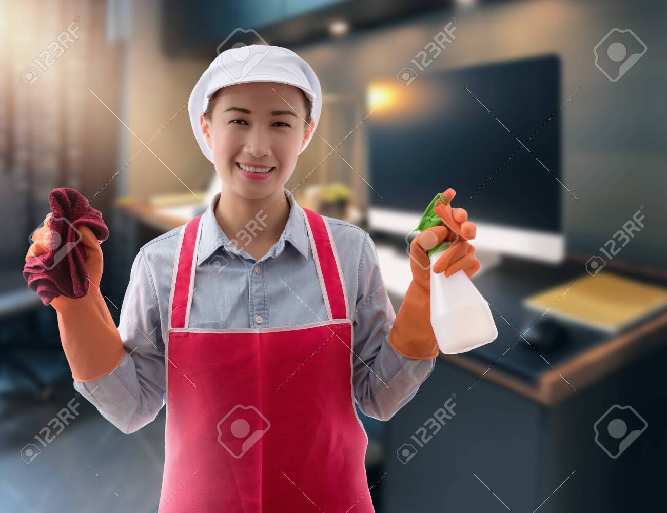 Cleaning concept Woman with bucket of washing fluids and rags in hands and cleaning equipment ready to clean house on blurred workingroom background - 147554605 Cleaning concept Woman with bucket of washing fluids and rags in hands and cleaning equipment ready to clean house on blurred workingroom background - 147554605