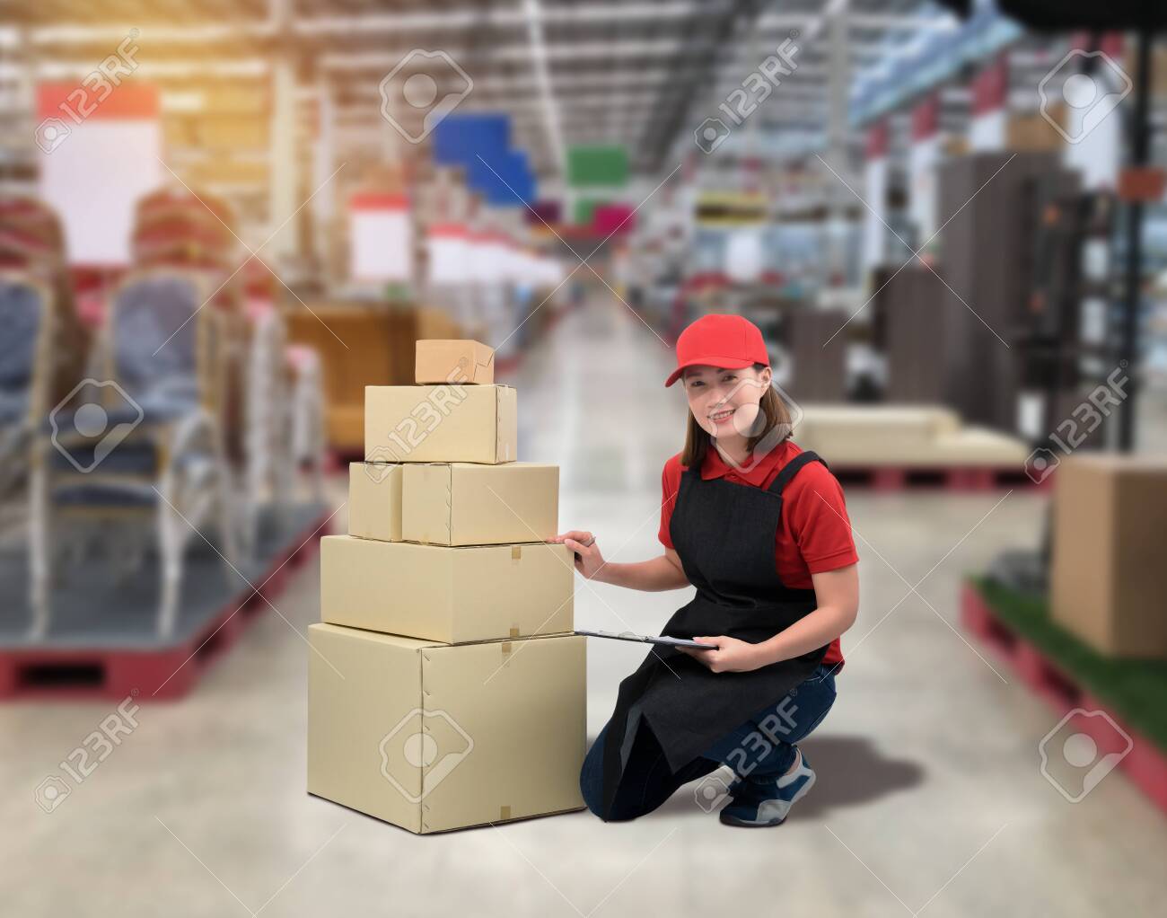 Female staff Delivering products Sign the signature on the product receipt form with parcel boxes Blurred the background of the warehouse - 148081579 Female staff Delivering products Sign the signature on the product receipt form with parcel boxes Blurred the background of the warehouse - 148081579