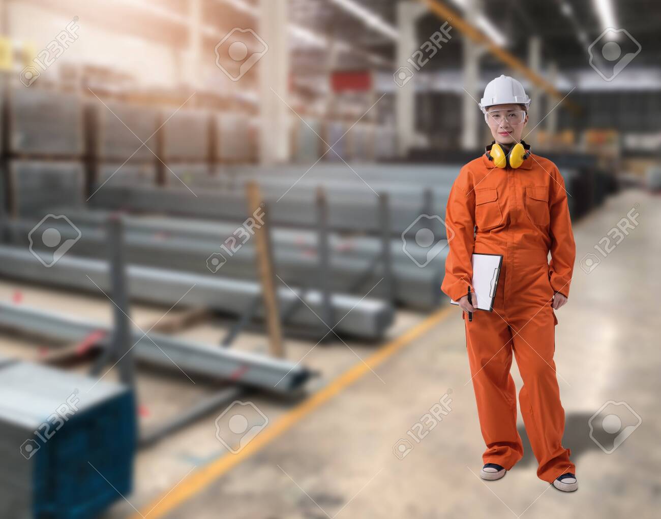 Portrait of Female staff warehouse operator with Blurred the background of Construction material on product shelf in store - 149184546 Portrait of Female staff warehouse operator with Blurred the background of Construction material on product shelf in store - 149184546
