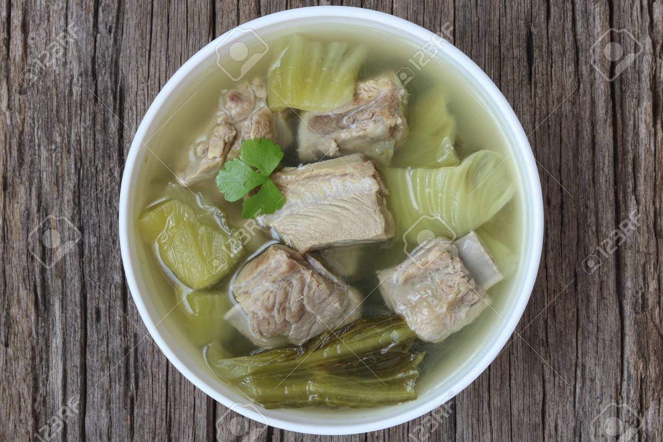 Pickled lettuce soup with spare ribs on wood background,close up - 111229444 Pickled lettuce soup with spare ribs on wood background,close up - 111229444