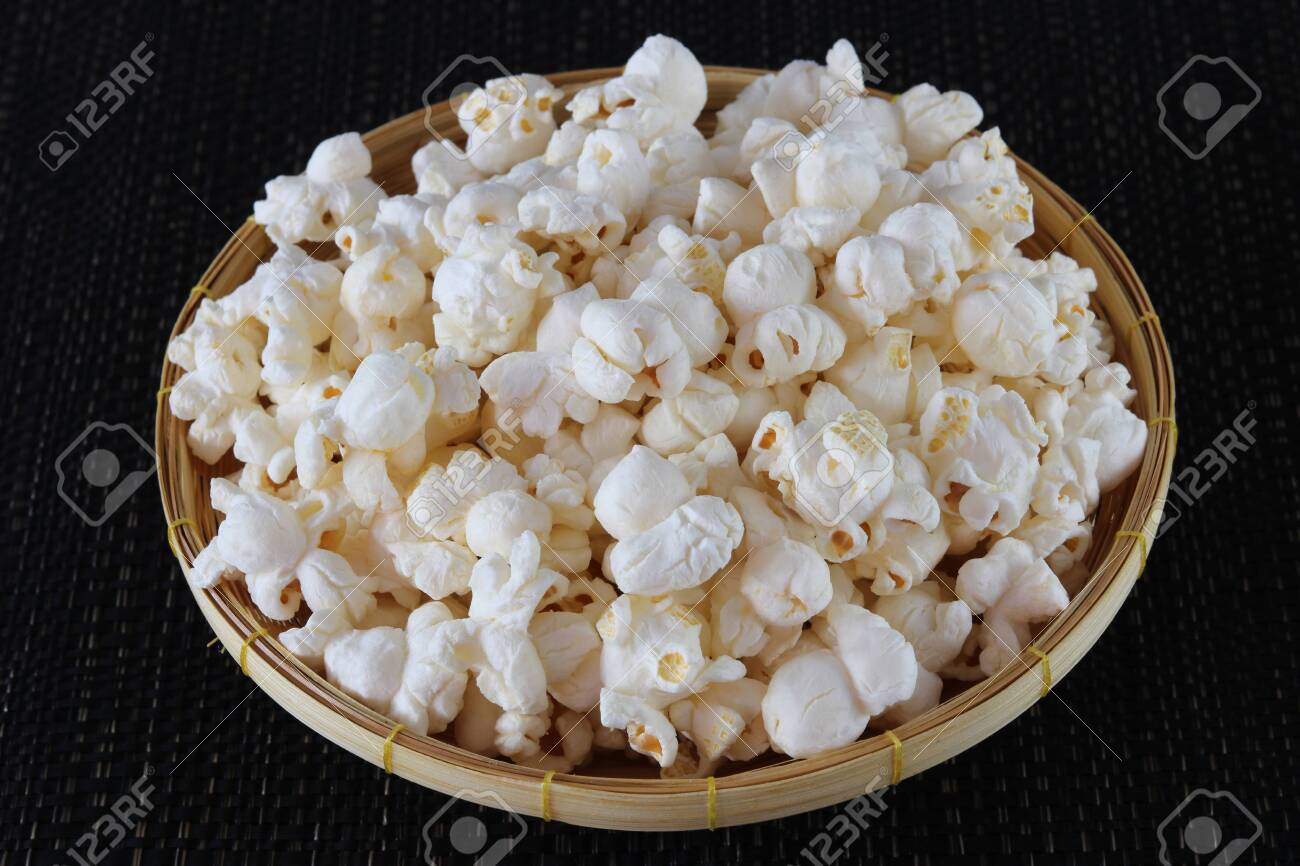 Popcorn in basket on black background close up - 134729924 Popcorn in basket on black background close up - 134729924