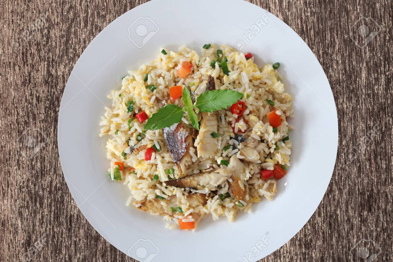 Fried rice with mackerel and egg top view on wood background - 155074880 Fried rice with mackerel and egg top view on wood background - 155074880