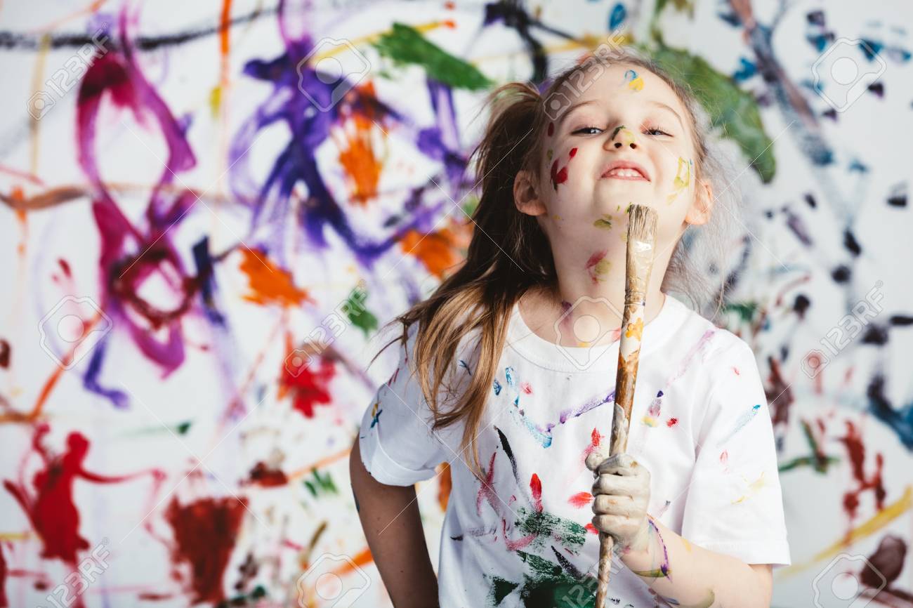Young Child Painter Standing With A Brush In Front Of A Messy.. Stock Photo, Picture And Royalty Free Image. Image 98027025.