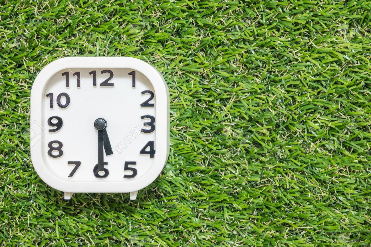 Closeup White Clock For Decorate Show A Half Past Five O Clock Or 5 30 P M On Green Artificial Grass Floor Textured Background With Copy Space Stock Photo Picture And Royalty Free Image Image