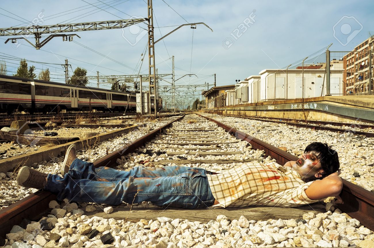 A Scary Zombie Taking A Nap At Abandoned Railroad Tracks Stock Photo,  Picture And Royalty Free Image. Image 32321226.