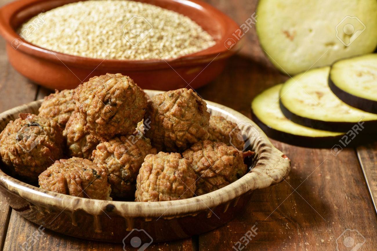 some vegan meatballs in an earthenware plate on a rustic wooden table, with some vegetables in the background - 49158887 some vegan meatballs in an earthenware plate on a rustic wooden table, with some vegetables in the background - 49158887