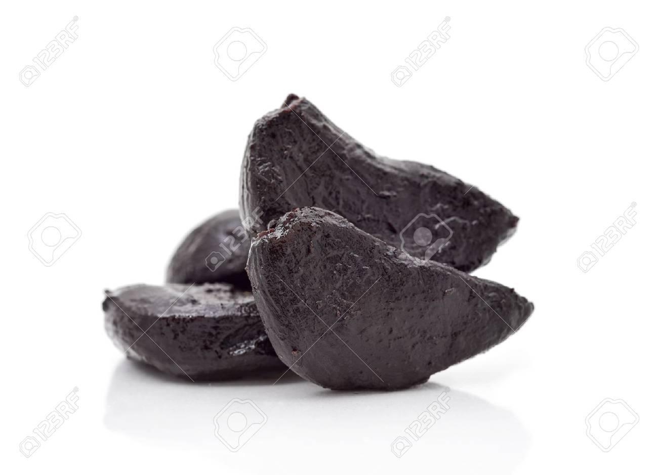 closeup of some black garlics on a white background - 63769849 closeup of some black garlics on a white background - 63769849