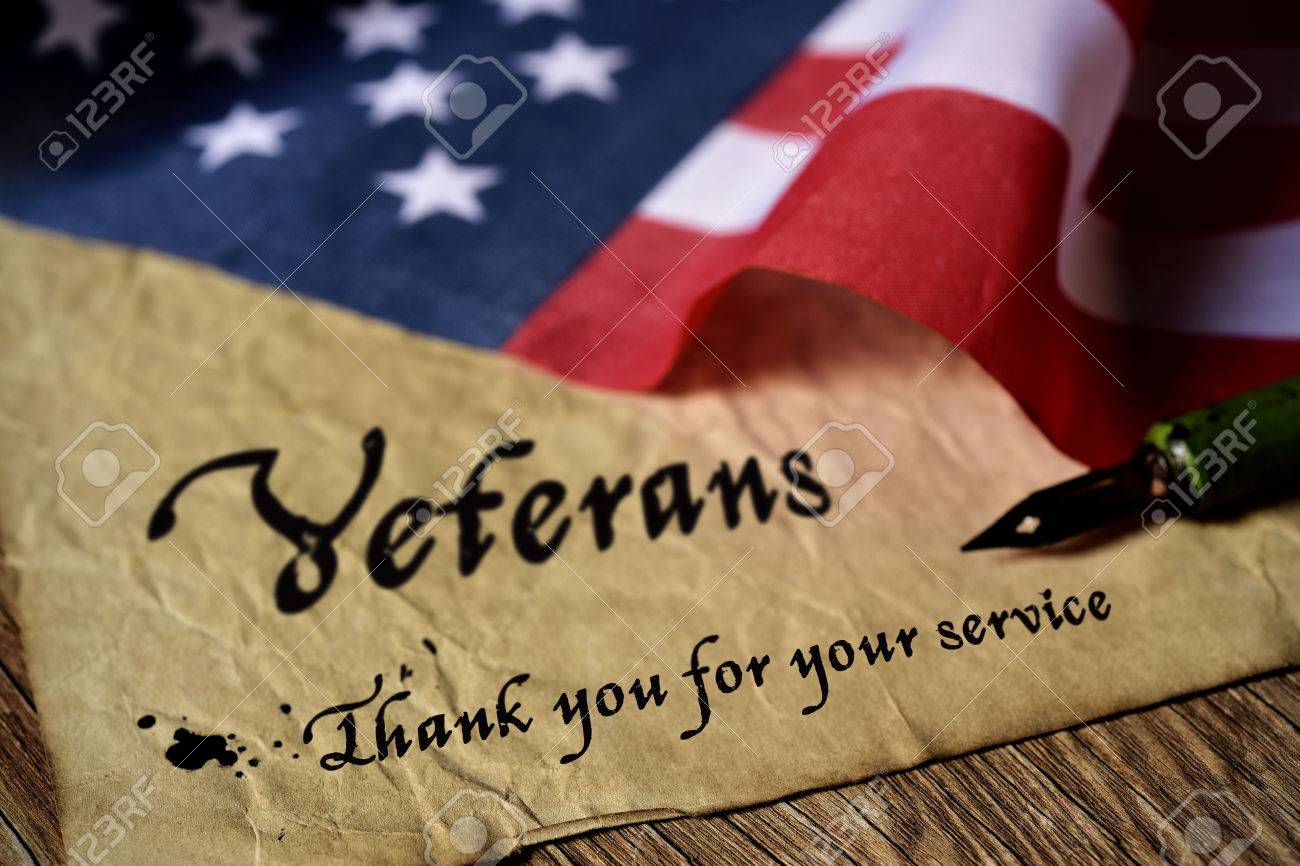 the text veterans than you for your service written in a piece of paper with a nib pen and a flag of the United States, on a rustic wooden background - 66157983 the text veterans than you for your service written in a piece of paper with a nib pen and a flag of the United States, on a rustic wooden background - 66157983