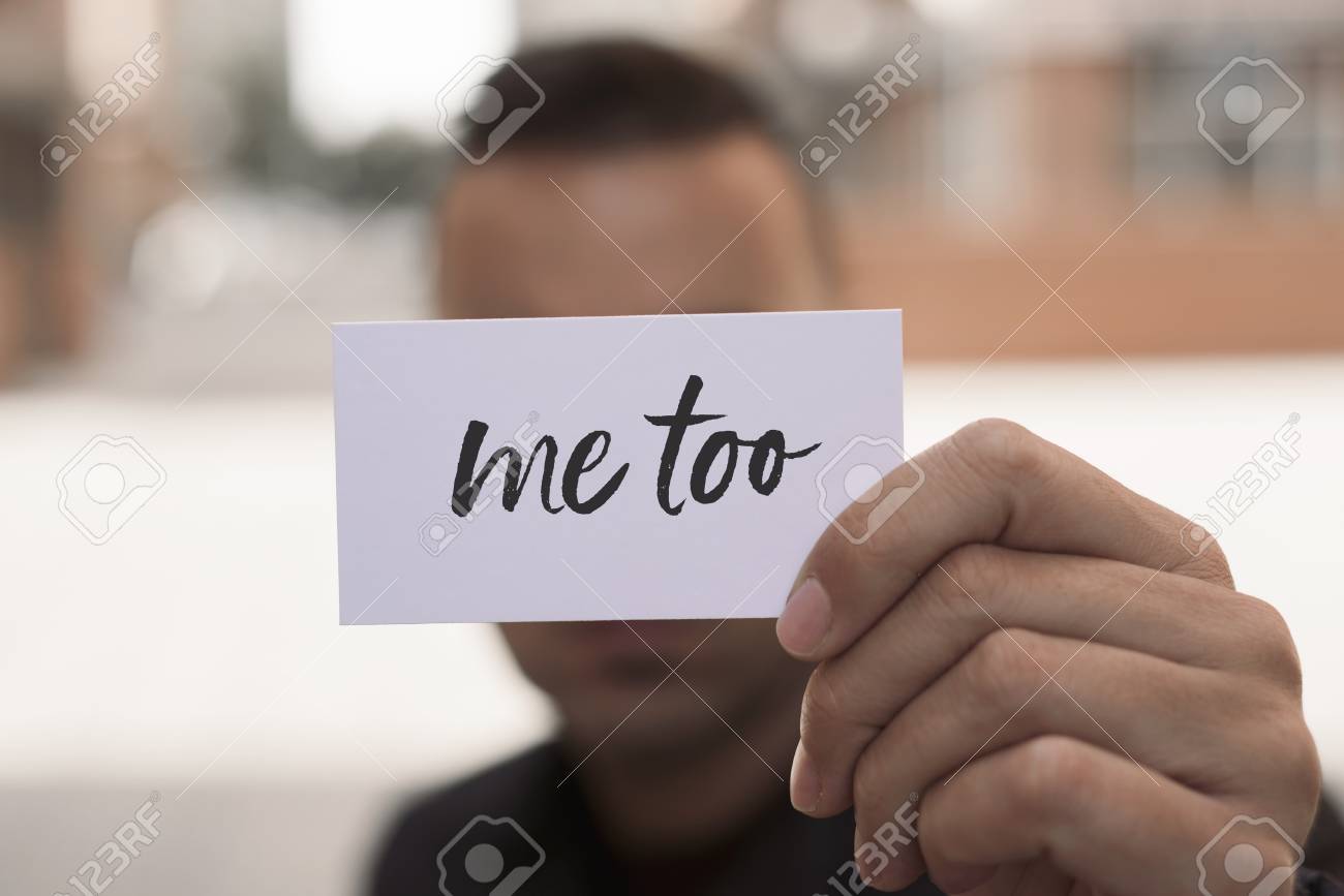 closeup of a young caucasian man in the street showing a piece of paper with the text me too written in it - 90607060 closeup of a young caucasian man in the street showing a piece of paper with the text me too written in it - 90607060