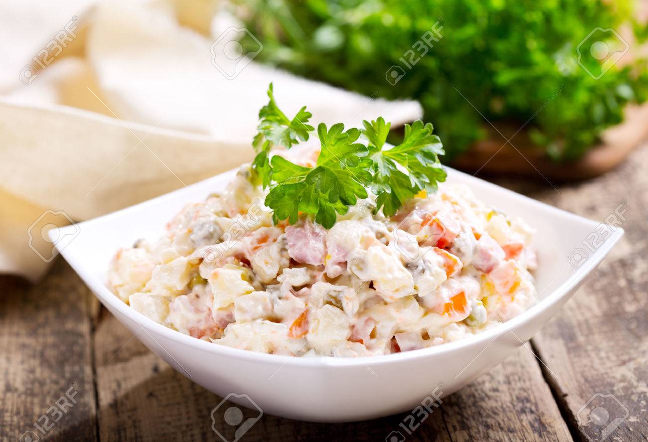 bowl of traditional russian salad on wooden table - 46521150 bowl of traditional russian salad on wooden table - 46521150