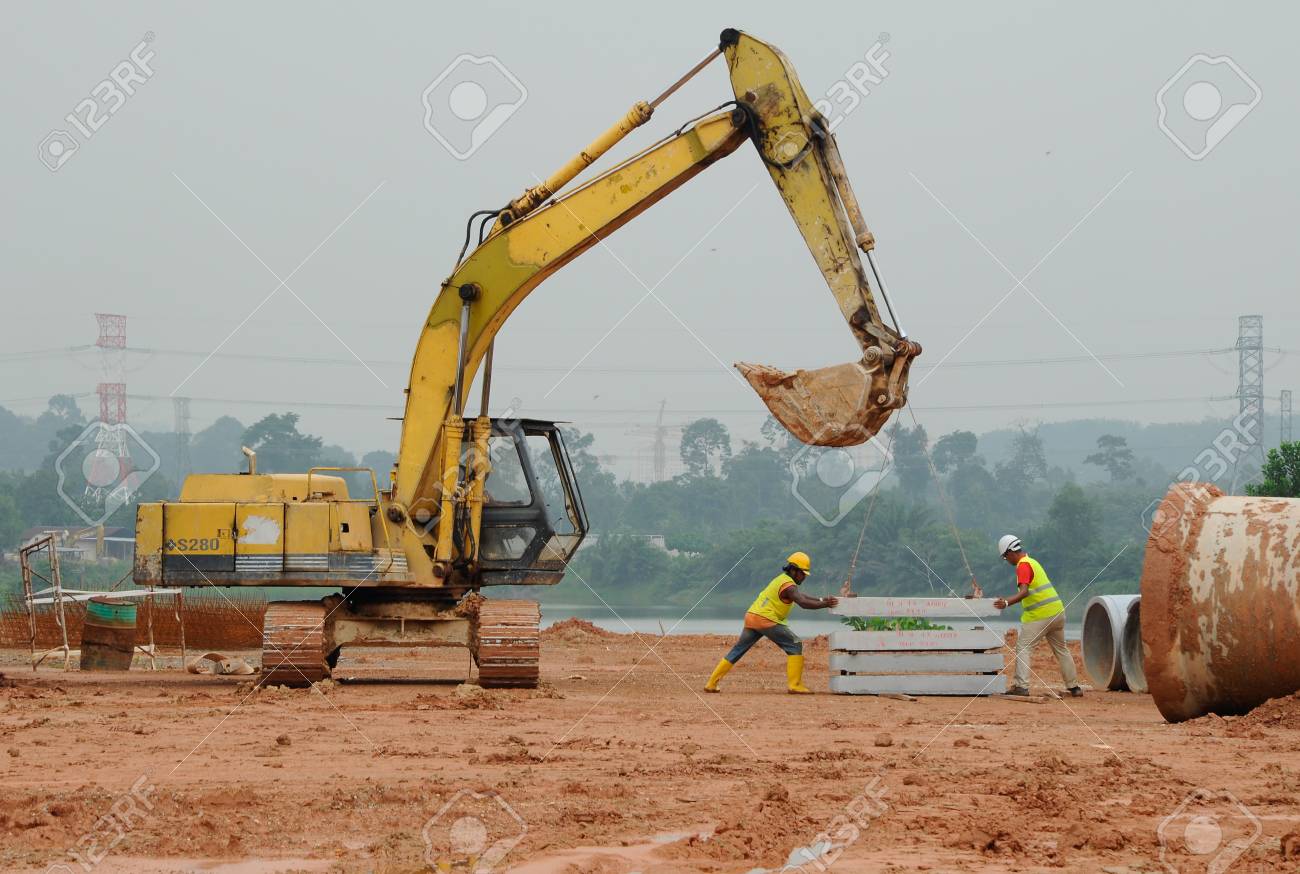 Two Construction Workers Lifting Concrete Floor Slab Using The Excavator Stock Photo Picture And Royalty Free Image Image 35832461