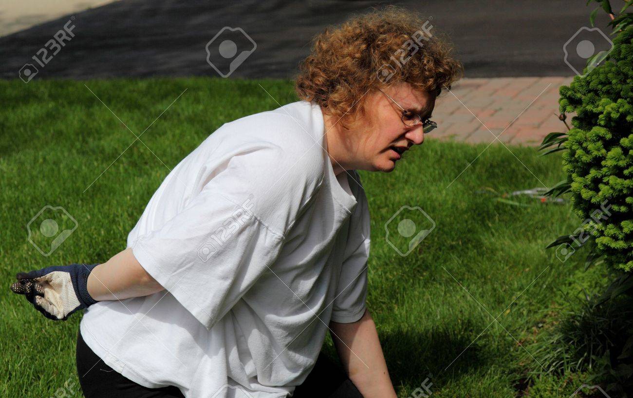 mature woman backache while gardening - 14282863 mature woman backache while gardening - 14282863