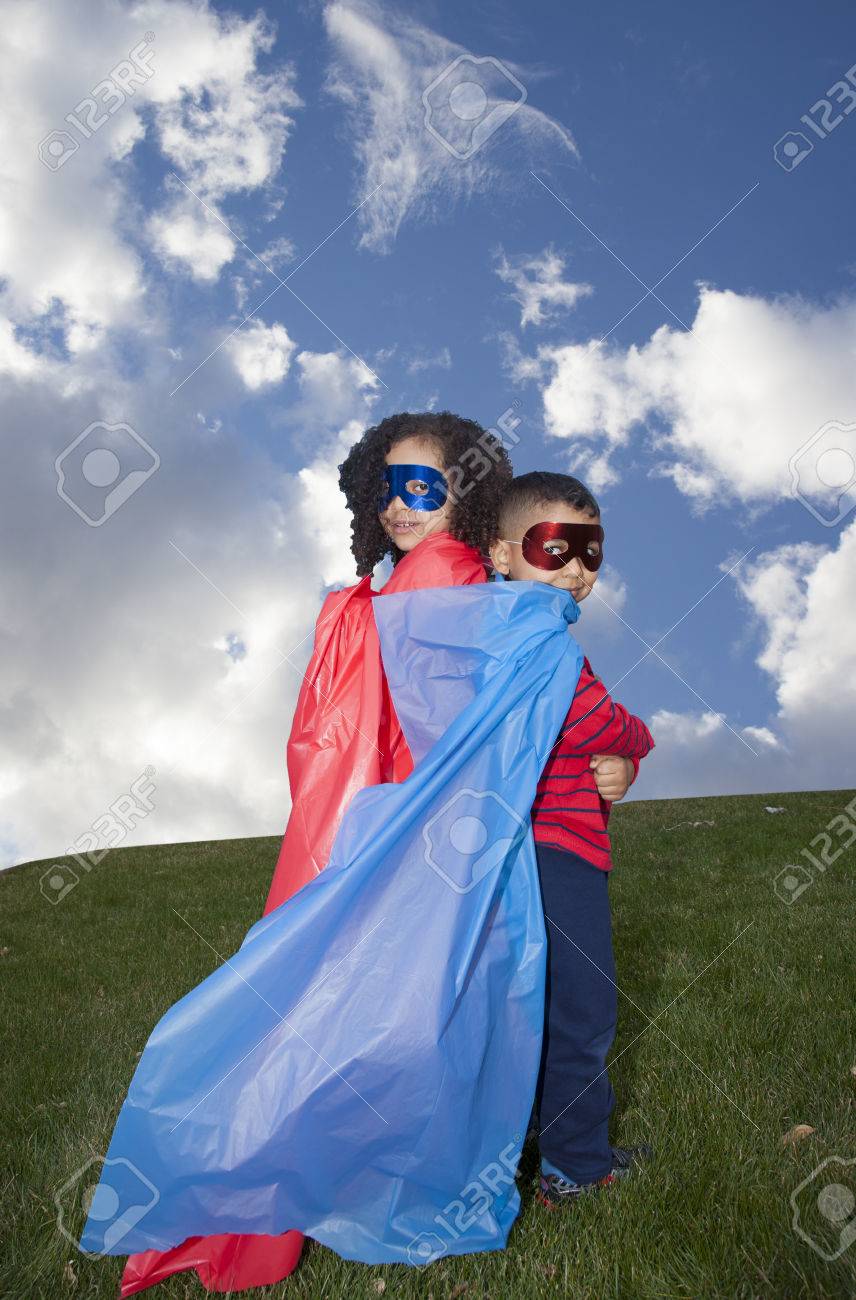 little boy and girl superheros against blue sky - 39761918 little boy and girl superheros against blue sky - 39761918