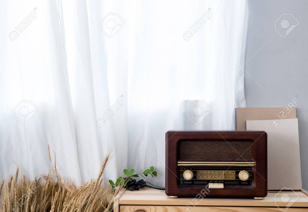 Old Vintage Radio With Shelf On The Wooden Cabinet Stock Photo