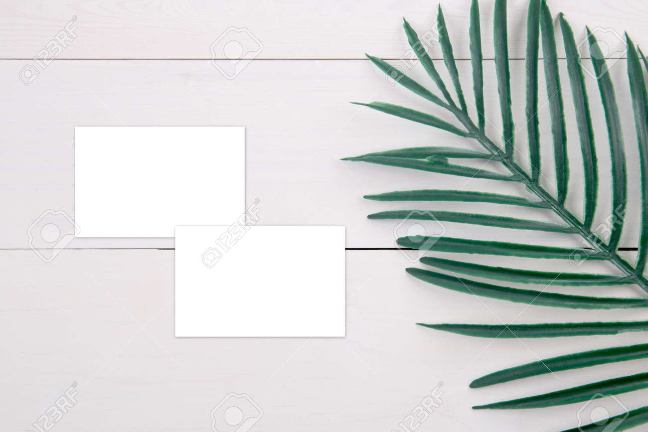 Business Card Mockup With Copy Space And Leaf On Wooden Table, Name Card  Blank And Leaves Decoration Your Design Or Branding, Mock Up Template,  Simplicity And Minimal, Nobody, Flat Lay, Top View.